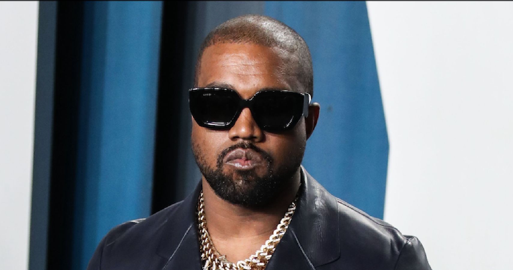 Kanye West wearing sunglasses on the red carpet 