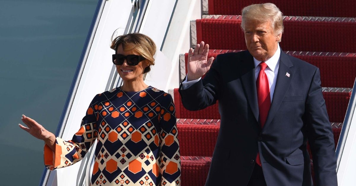 Melania and Donald Trump waving at people