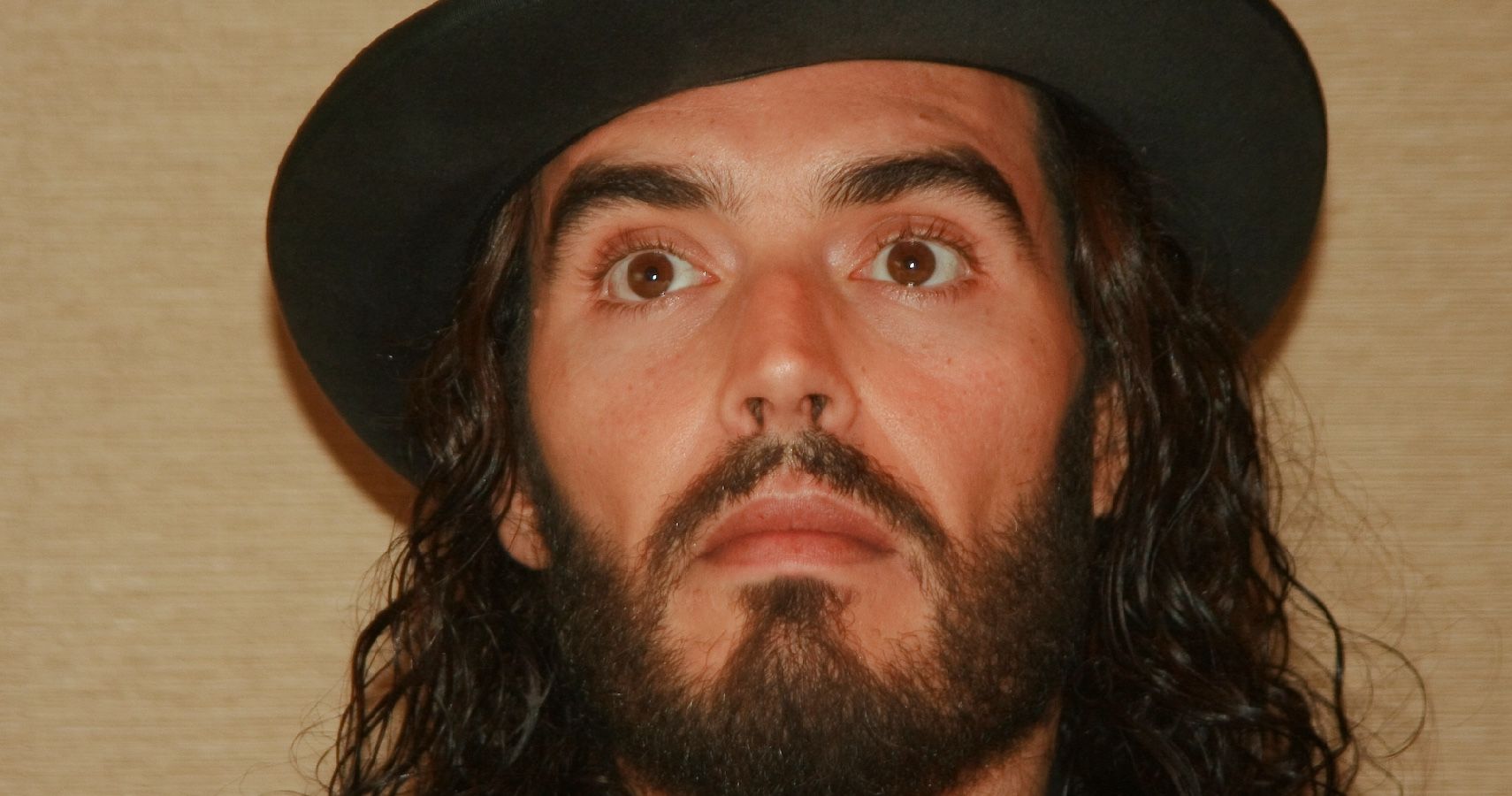 Russell Brand wearing a hat 