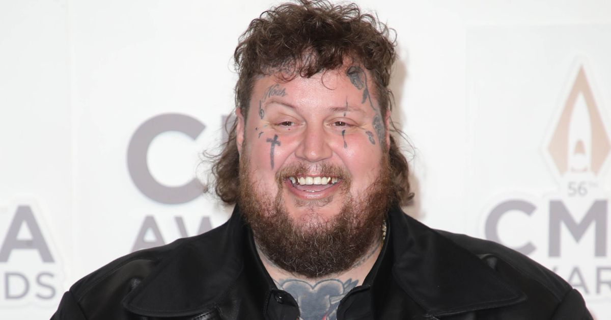 Jelly Roll smiling on a red carpet
