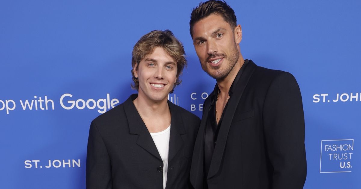 Lukas Gage and Chris Appleton smiling on a red carpet