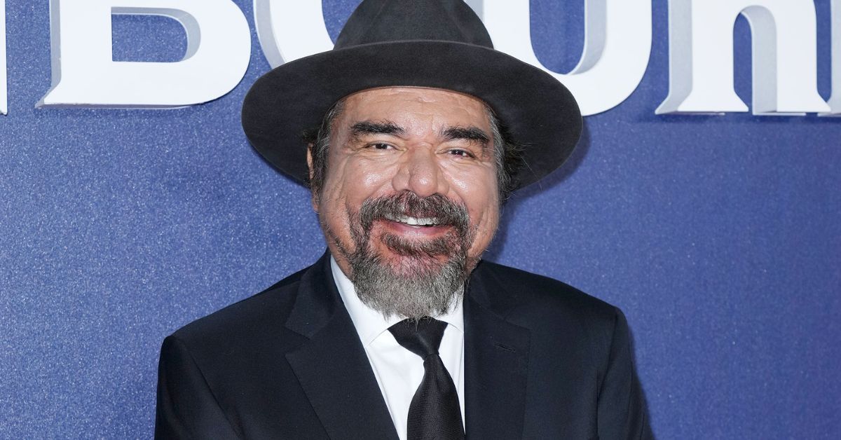 George Lopez smiling on a red carpet