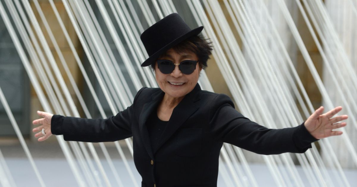Yoko Ono with her arms wide open