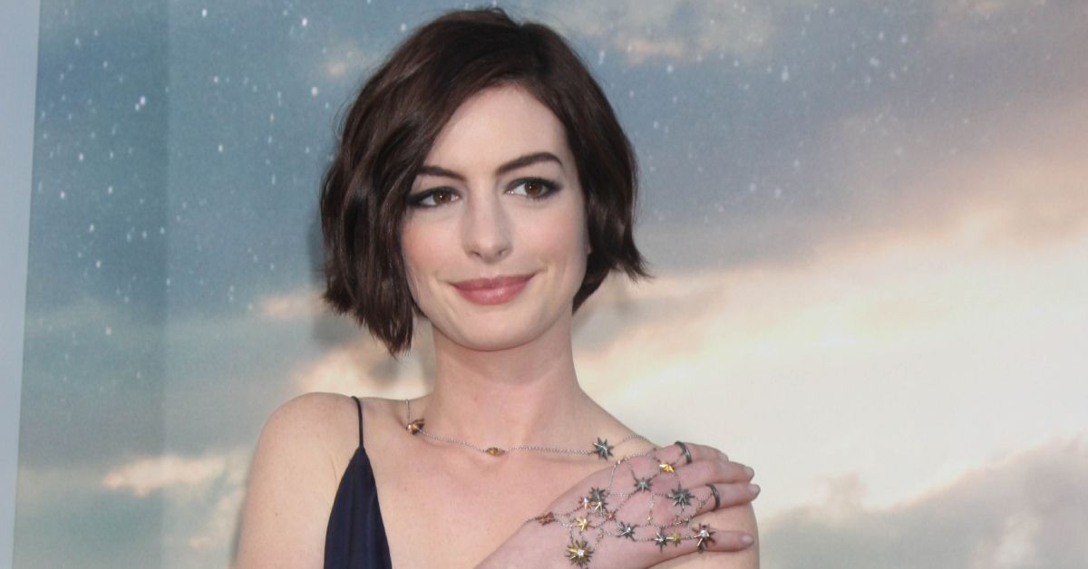 Anne Hathaway with her hand on his shoulder