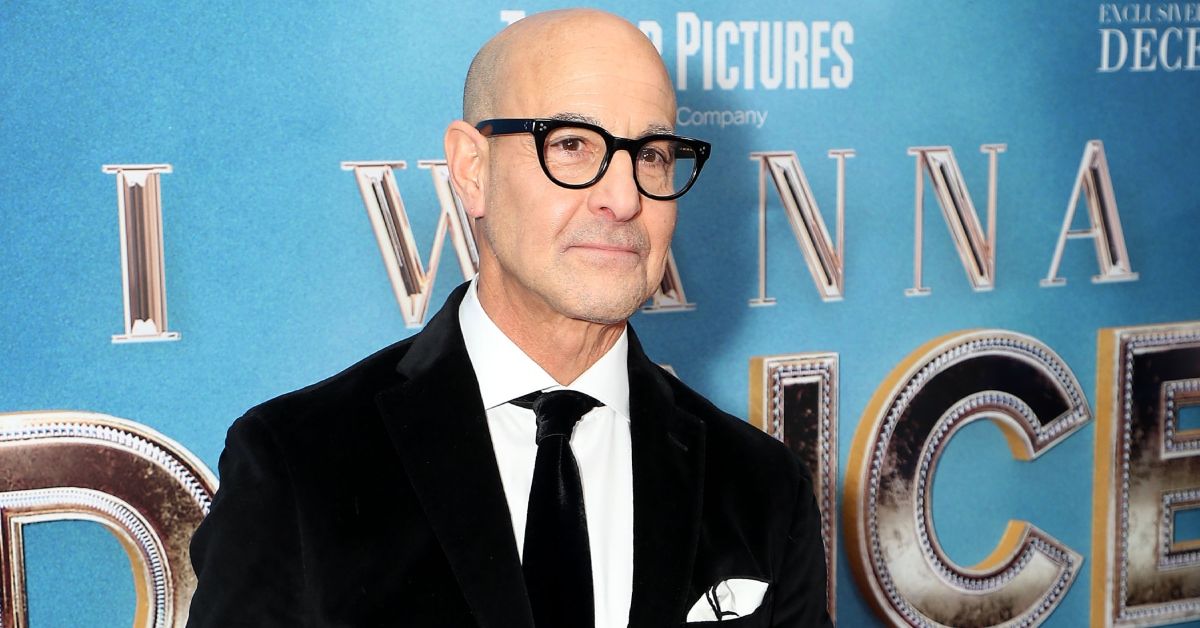 Stanley Tucci smiling on the red carpet of a movie premiere