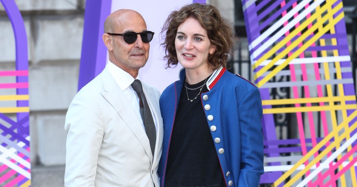 Stanley Tucci and Felicity Blunt standing on a red carpet