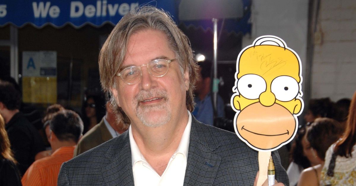 Matt Groening holding up an image of Homer Simpson
