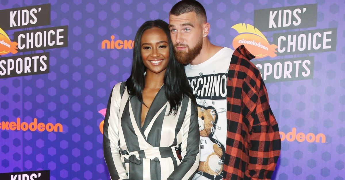 Kayla Nicole and Travis Kelce posing for a photo on a red carpet