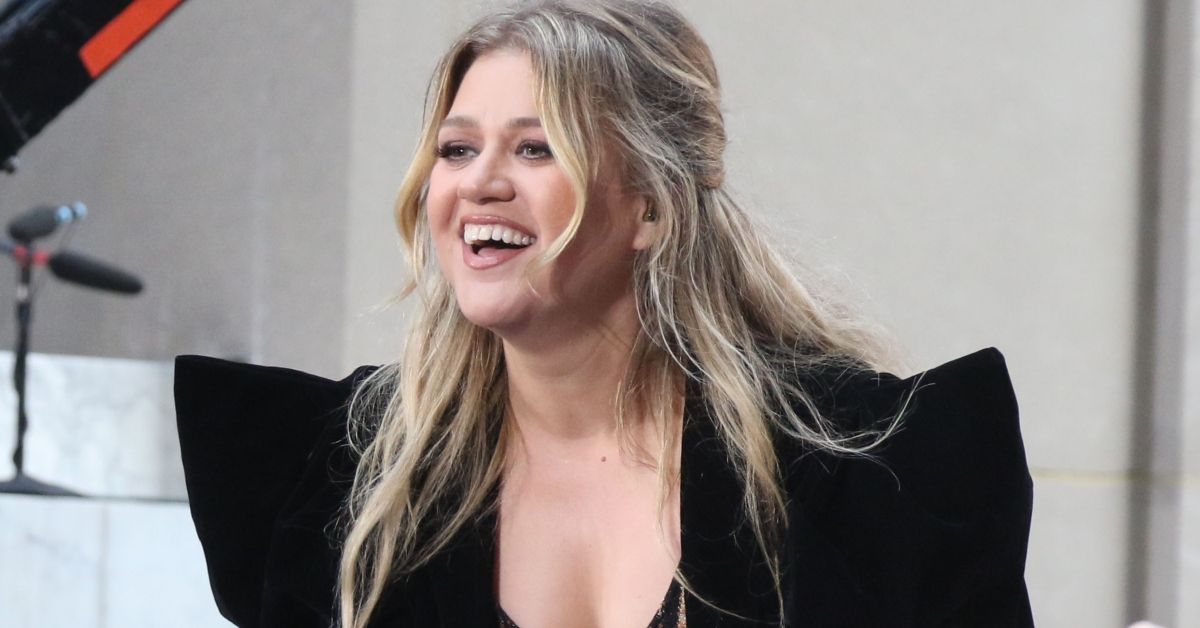 Kelly Clarkson smiles while performing