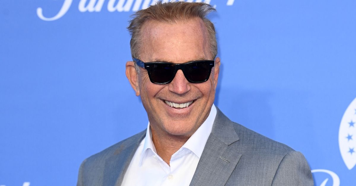 Kevin Costner smiling and wearing sunglasses
