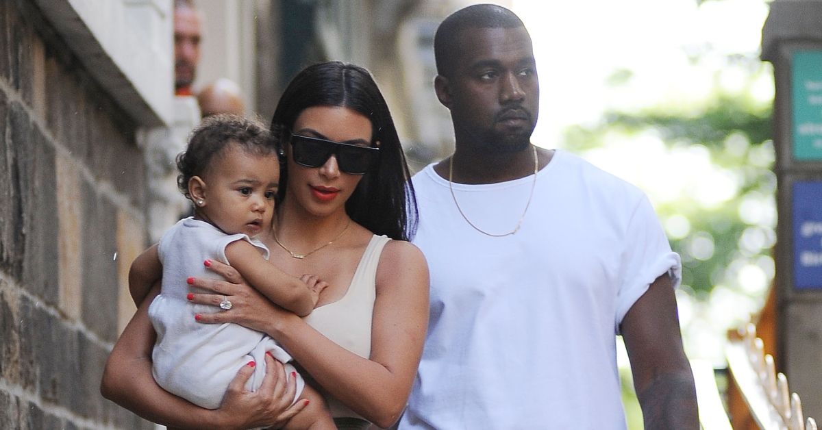 Kim Kardashian and Kanye West walk with North West
