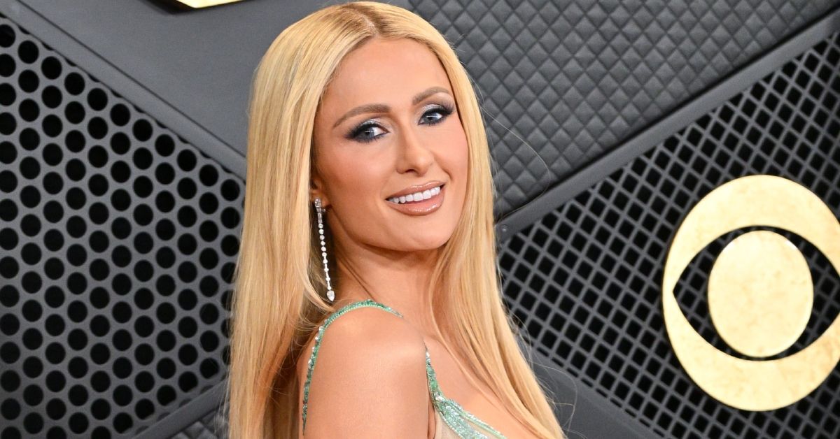 Paris Hilton smiling on the red carpet at the Grammy Awards