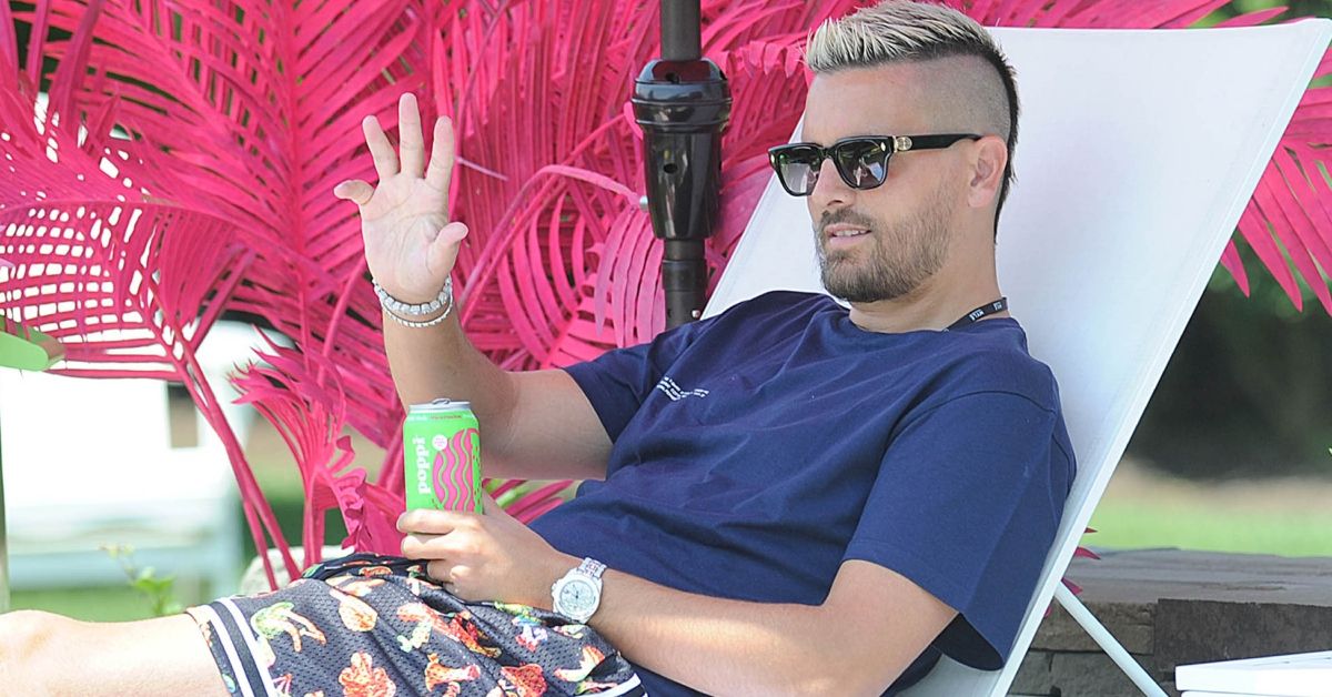 Scott Disick waves while relaxing