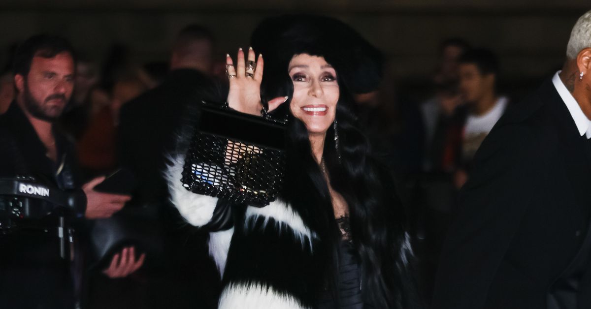 Cher waving to the crowd outside