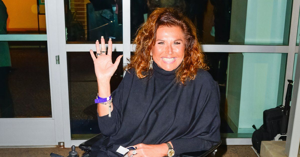 Abby Lee Miller waves at cameras