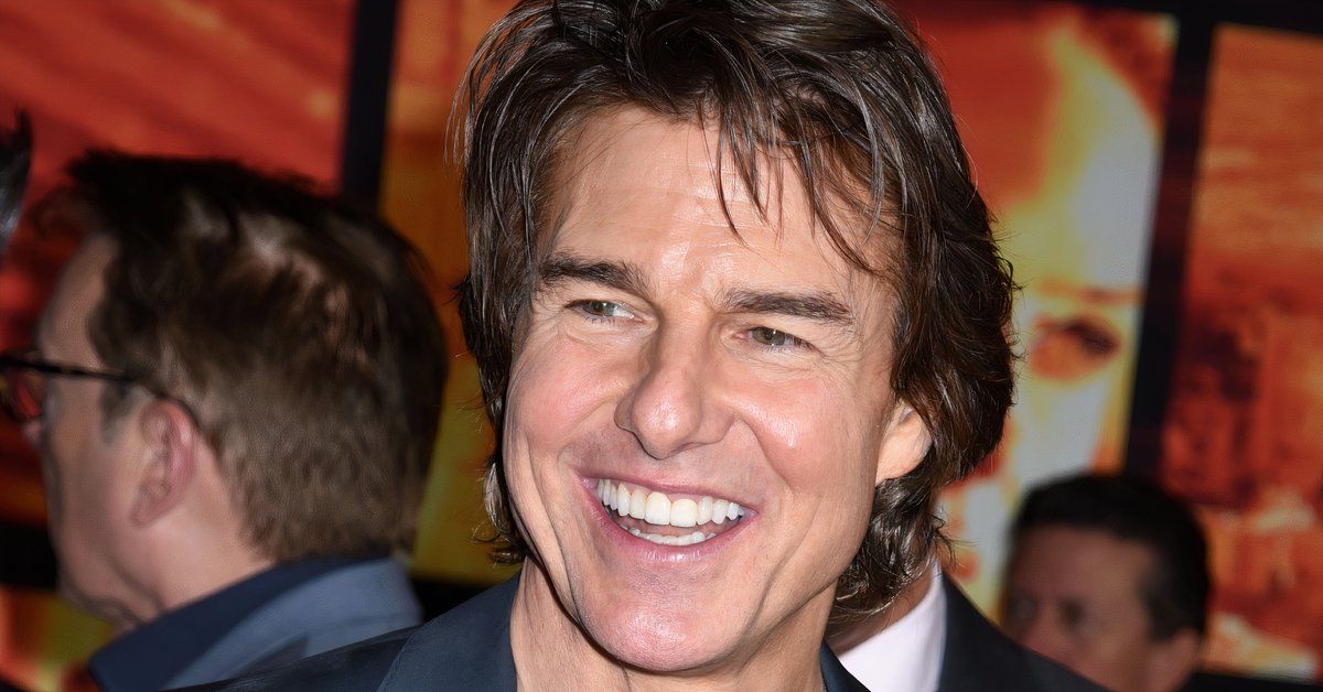 Tom Cruise smiles while attending an event