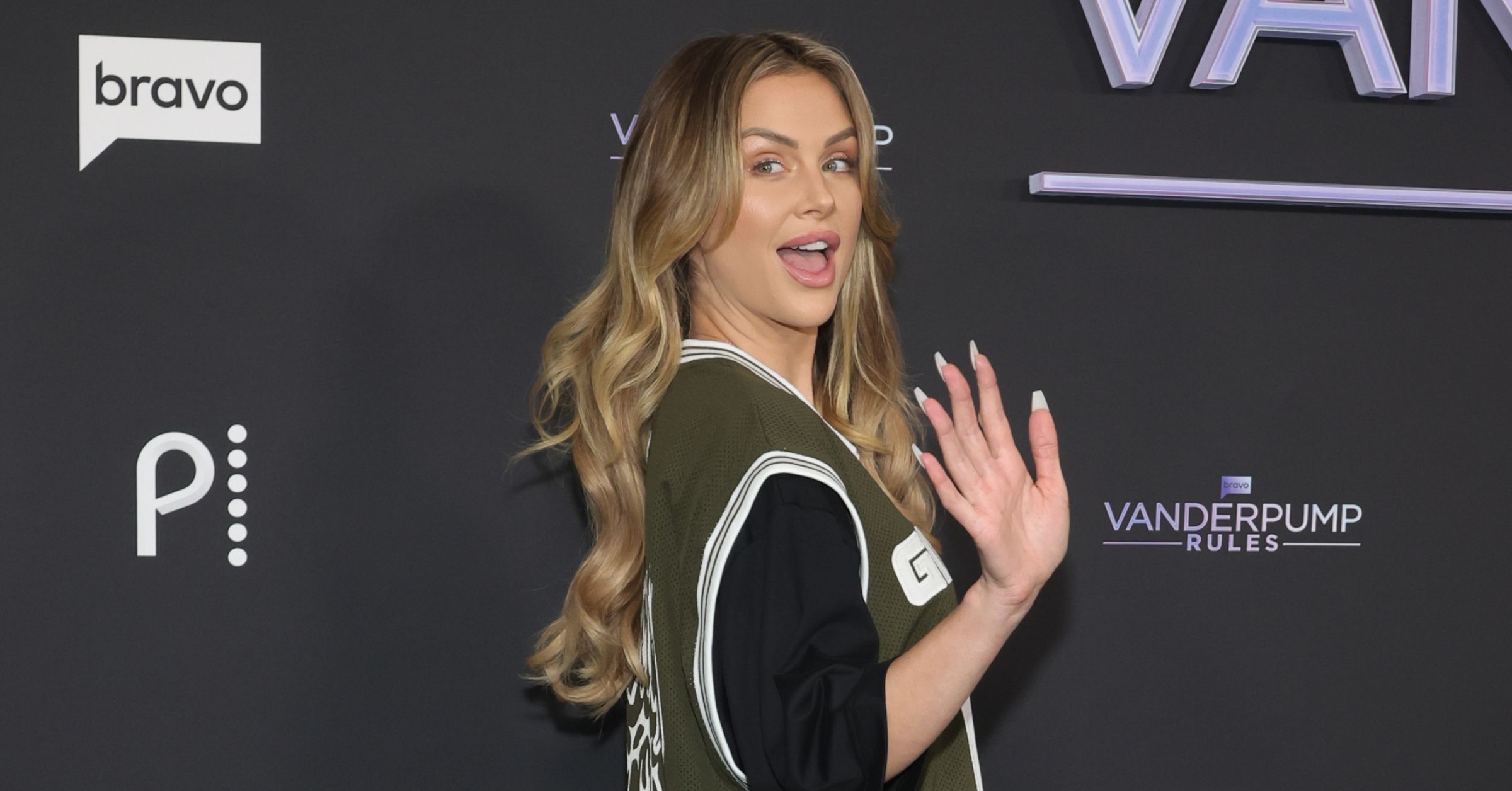 LaLa Kent waves to cameras