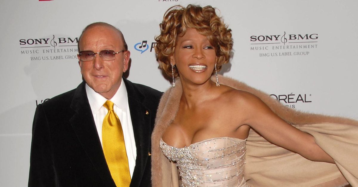 Whitney Houston and Clive Davis smiling