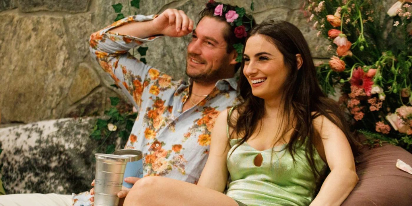 Paige and Craig sitting next to each other with flowers on Winter House