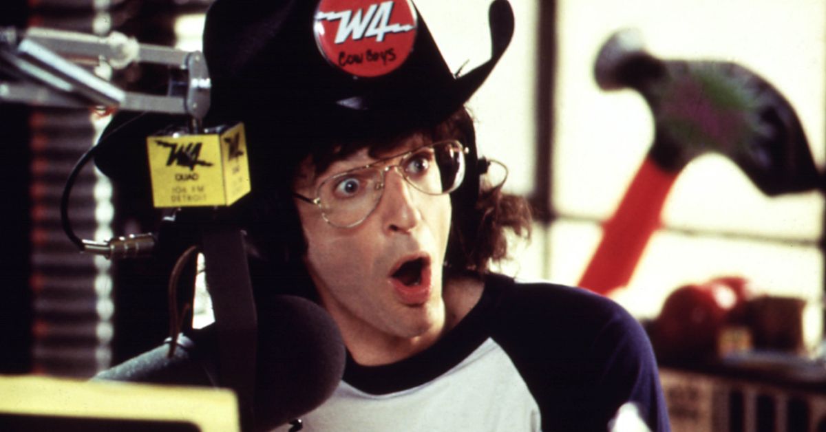 Howard Stern looking shocked behind a radio microphone