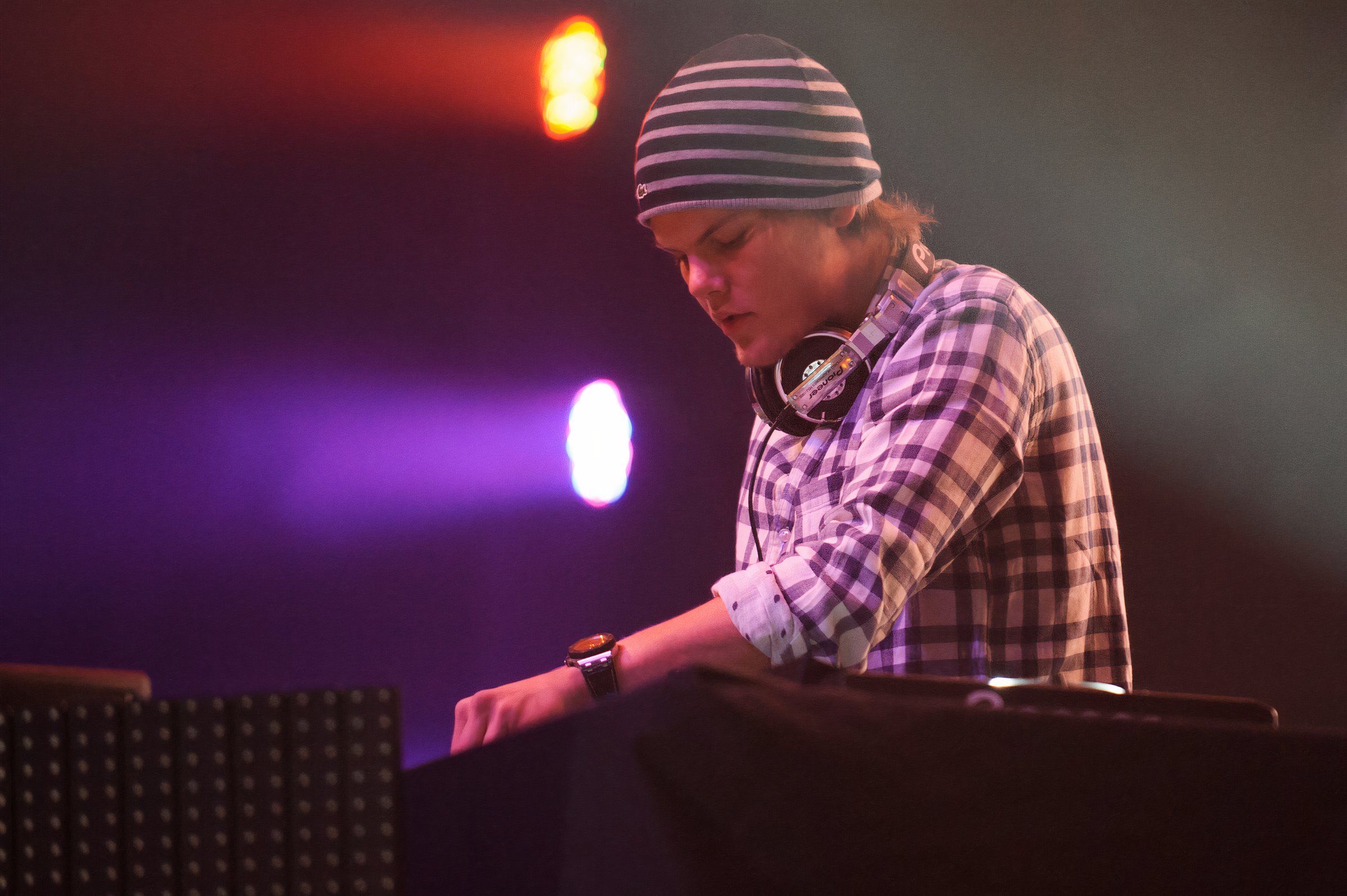 a dj performs on a stage