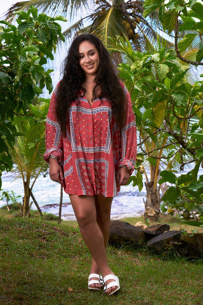 woman in red dress posing on island