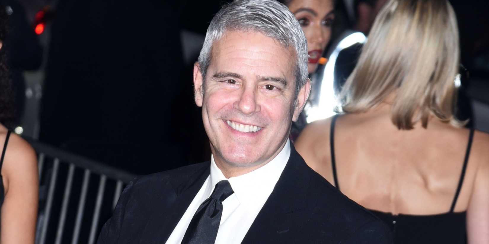 Andy Cohen smiling at an event 