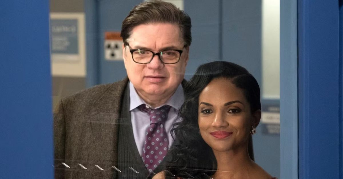 Chicago Med's Mekia Cox and Oliver Platt looking through a door