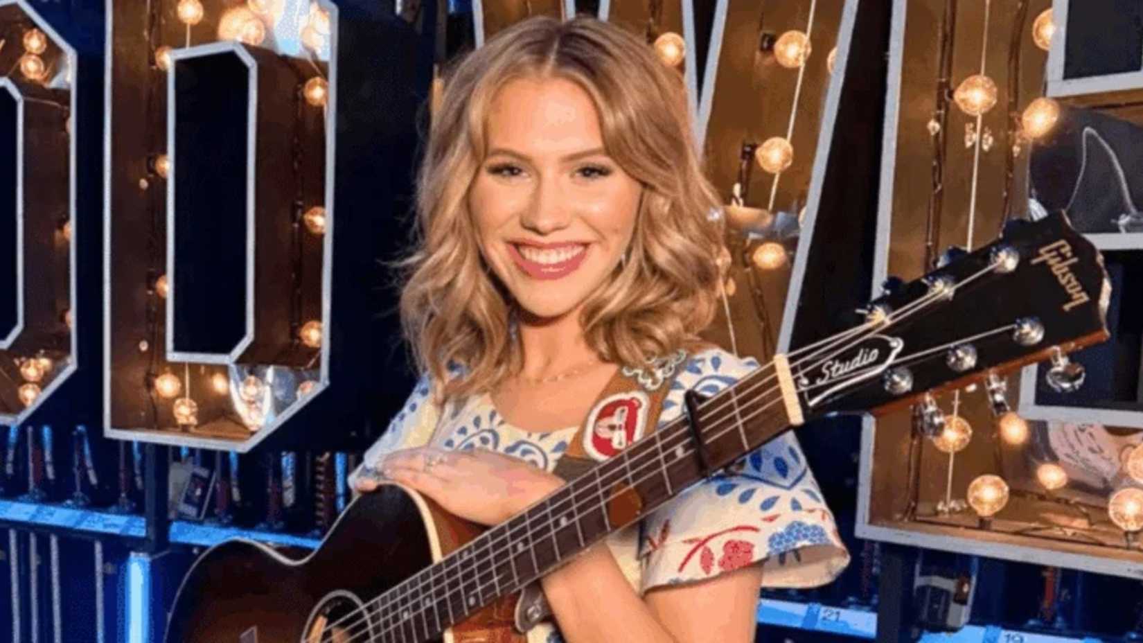 American Idol season 24 winner Hannah Harper smiles and holds a guitar