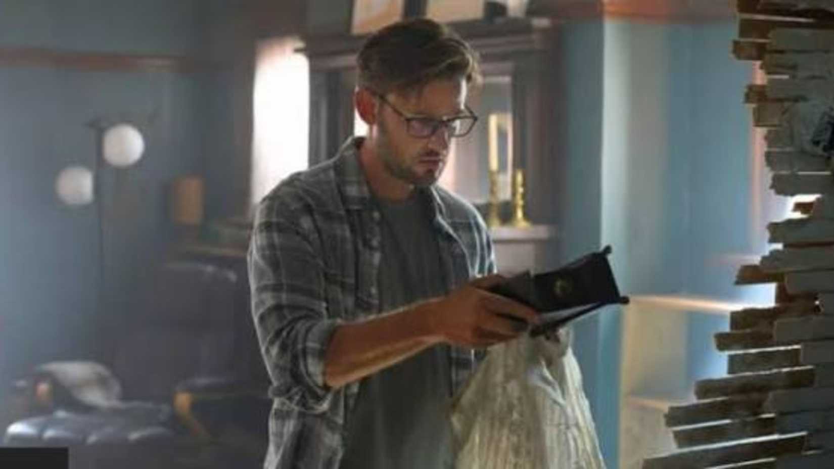 Elliot Augustine from The Way Home holding the clock from inside the wall